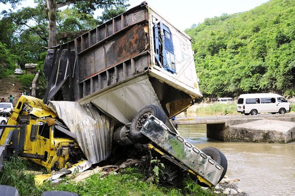 Norman Grindley/Chief Photographer
Forty-five year-old Michael Nicholas and his son, 18-year-old Travis, are among three men who died wednesday night when their trailer plunged into the Rio Cobre.