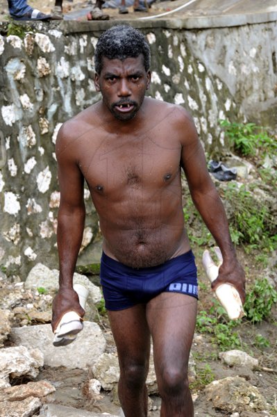 Norman Grindley/Chief Photographer
People in the Bog Walk Gorge kept busy fishing for meat in the river after a tailor transporting meat plunged into the Rio Cobre in St Catherine. Forty-five year-old Michael Nicholas and his son, 18-year-old Travis, are among three men who downed Wednesday night.