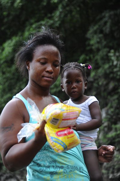 Norman Grindley/Chief Photographer
People in the Bog Walk Gorge kept busy fishing for meat in the river after a tailor transporting meat plunged into the Rio Cobre in St Catherine. Forty-five year-old Michael Nicholas and his son, 18-year-old Travis, are among three men who downed Wednesday night.