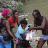 Norman Grindley/Chief Photographer
People in the Bog Walk Gorge kept busy fishing for meat in the river after a tailor transporting meat plunged into the Rio Cobre in St Catherine. Forty-five year-old Michael Nicholas and his son, 18-year-old Travis, are among three men who downed Wednesday night.