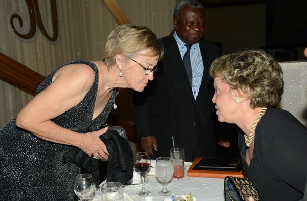 Rudolph Brown/Photographer
Patricia Foote, (left) chat with Carla Saga at Admark 50th Anniversary Banquet at  at the Jamaica Pegasus on Tuesday, April 14
