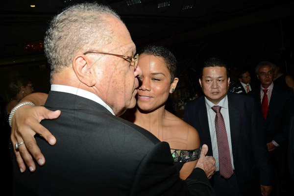 Rudolph Brown/Photographer
Arnold Foote greets by his granddaughter Alexisse Chin while Peter Chin looks on at Admark 50th Anniversary Banquet at  at the Jamaica Pegasus on Tuesday, April 14