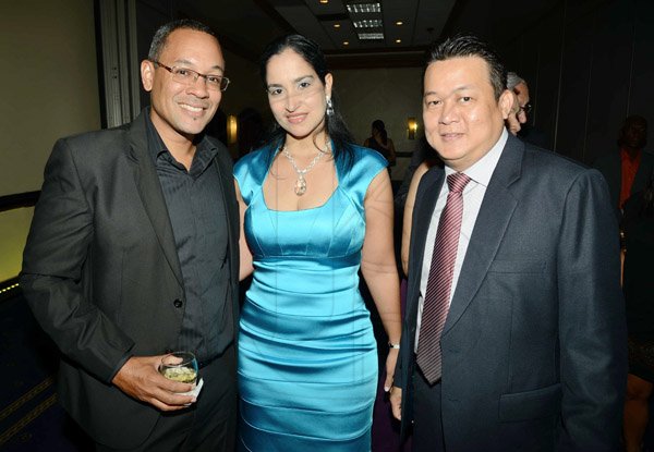 Rudolph Brown/Photographer
Chridtopher Barnes, (left) pose with Peter Chin and his wife Arlene Chin at Admark 50th Anniversary Banquet at  at the Jamaica Pegasus on Tuesday, April 14