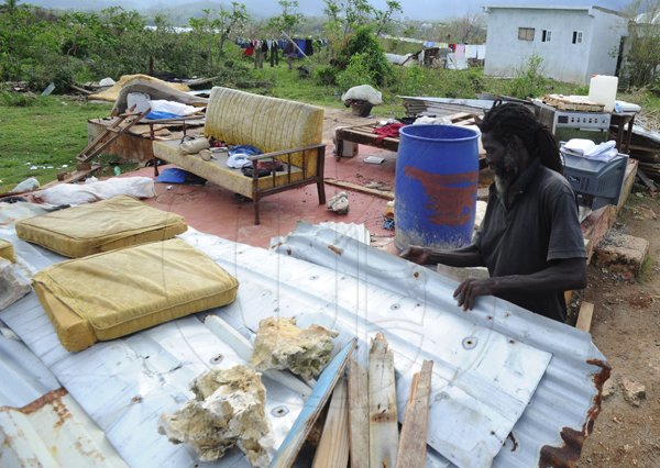 Ricardo Makyn/Staff Photographer 
 Devon Richards seeing what He can salvage from what was His  House that  was totally destroyef by Hurricane Sandy  in  Sandshore   Manchioneal Portland