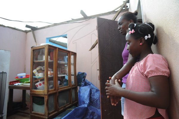 Ricardo Makyn/Staff Photographer 
 Alashia Parker with Daughter Calecia Gibson in thier Home that is now roofless in    Manchioneal Portland  due to  the passage of  the Hurricane Sandy