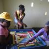 Ricardo Makyn/Staff Photographer 
Residents play a gameof Ludo in the Community Centre in  Manchioneal Portland that is being used as a Shelter for over 30 person's that were displaced due to  the passage of Hurricane Sandy