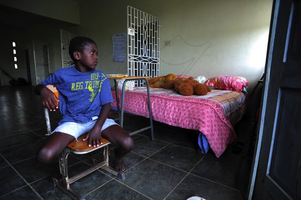 Ricardo Makyn/Staff Photographer 
Demetre Powell sits next to a Bed in the Community Centre in  Manchioneal Portland that is being used as a Shelter for over 30 person's that were displaced due to  the passage of Hurricane Sandy