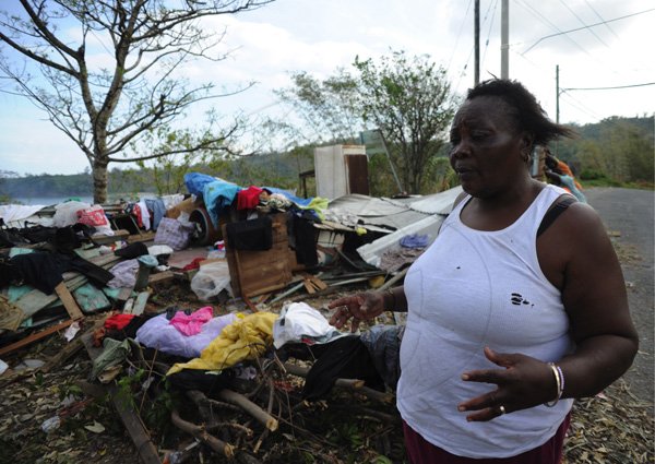 Ricardo Makyn/Staff Photographer 
Corena Stewart of Grange Hill Portland shows what remains of Her Home after the passage of Hurricane Sandy