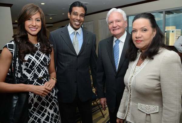 Rudolph Brown/Photographer
From left are Kerrie Baylis, Gerald Wight of RCW Capital, David Banmiller and Michelle Hussey, Managing Director of Terra Nova Hotel at the AMCHAM Digicel Christmas  luncheon EXTRAVAGANZA at the Jamaica Pegasus Hotel on Thursday, December 5, 2013