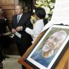 Ricardo Makyn/Staff Photographer
Prime Minister Bruce Golding walks by a portrait of the late Professor Barry Chevannes at the funeral held for the educator at the University of the West Indies Chapel in St Andrew yesterday. See story on A3
