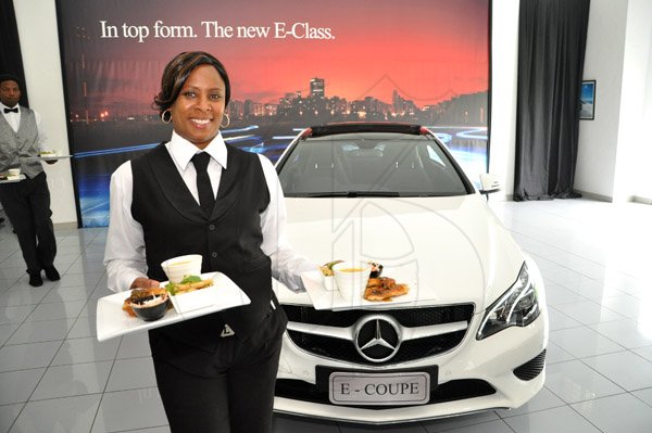 Jermaine Barnaby/Photographer
Waitress Lamour Gordon serves up lunch at The New E-Class Sedan launched on Monday, September 9, 2013 Silver Star Motors Limited, South Camp Rd, Kingston.