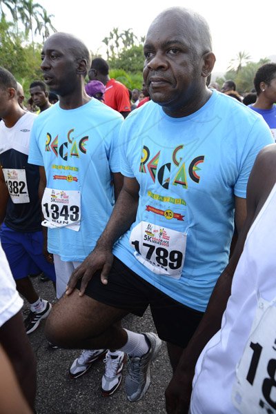 Rudolph Brown/Photographer                                                                                                                                                 Senator Floyd Morris warm up beside Donovan Jacas at the Best Dressed Chicken 5K road race at Hope Gardens in Kingston on Sunday, March 24, 2013