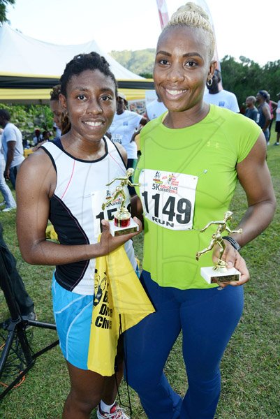 Rudolph Brown/Photographer
Kim-Marie Spence, (left) and Murlene Dudley pose with their trophy after the Best Dressed Chicken 5K Road Race Series 2013 at Hope Garden on Sunday, March 24, 2013.