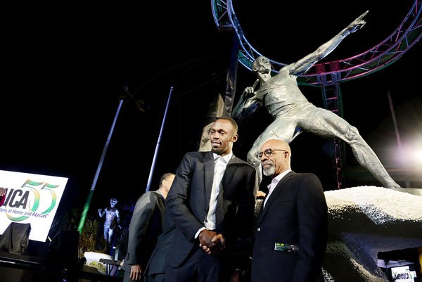 Rudolph Brown/PhotographerSculptor Basil Watson, (right) shake Usain Bolt hand at the Unveiling of Usain Bolt statue at the National Stadium on Sunday, December 3, 2017 *** Local Caption *** Rudolph Brown/PhotographerSculptor Basil Watson, (right) shakes hands with Usain Bolt during the unveiling of the sprinter's statue at the National Stadium yesterday.