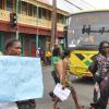 Jermaine Barnaby/Photographer
Protestors marching up Half Way Tree infront a JUTC bus where they staged a peaceful demonstration against bus fare increase in Half way Tree on Monday August 25, 2014.