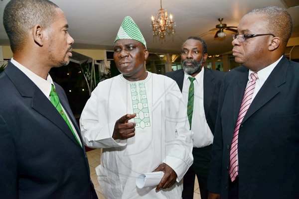 Rudolph Brown/Photographer
Ambassador Olatokunboh Kamson, (second left) Nigerian High Commissioner to Jamaica chat with from left Keith White, President of Calabar Old Boys Association, (COBA), past President John Messam and Michael Roofe, Chairman of Dinner Committee at the Calabar Old Boys Annual Reunion Dinner at the Mona Visitors Lodge on Saturday, October 5, 2013