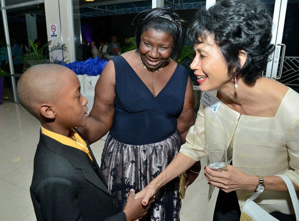 Rudolph Brown/Photographer
Patricia Kong Ting, Board Director of Caribbean Airline greets 7th Heaven Frequent Flyer Cecile Bryan and Nephew Jalon Duncan  at the Caribbean Airlines awards and Corporate Event at the Jamaica Pegasus Hotel on Friday, November 15, 2013
