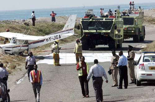Norman Grindley/Chief Photographer
This single engine Cessna plane overshot the run way at the Norman Manley International Airport in Kingston and crash on the Port Royal road about 10:25 am. The pilot and another passenger were taken to hospital.
