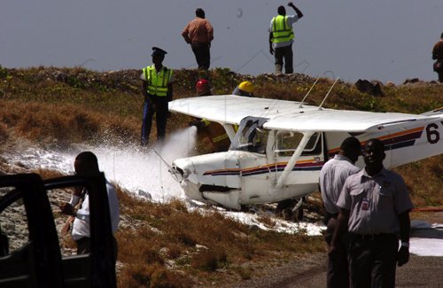 Norman Grindley/Chief Photographer
This single engine plane shot the run way at the Norman Manley international air port in Kingston and crash on the Port Royal road about 10:25 am  March 4, 2011. The pilot and another passenger were taken to hospital.