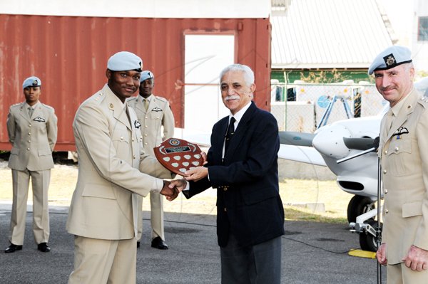 Contributed
Lieutenant Osmar Fiddler receives a plaque for being the top student from Minister of National Security Colonel Trevor MacMillan recently. In the background are Lt Melecia Sinclair and Lt Victor Dawkins, who along with Fiddler became the first persons to be trained as military pilots at the Jamaica Military Aviation School. 
CROP OUT MAN AT RIGHT

 Also sharing in the occasion is Lt. Col. Geoffrey Roper, Commanding Officer at the JDF Air Wing.