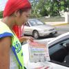 Jermaine Barnaby/Photographer
Dancehall Diva D' Angel (left) tries to persuade a motorist to buy a copy of The Gleaner newspaper during the company's corporate street sale day just outside Devon House on Monday September 8, 2014.