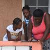 Grade four student at Golden Grove Primary and Infant School in St Thomas, Kheniece Thompson (left), gets help from Tamara Russell (right), her godmother, to access schoolwork from a cell phone shortly after it was sent by her teacher recently. Looking on is Tamila Rowe, student of Happy Grove High School in Portland. Since the closure of schools islandwide because of the COVID-19 pandemic, students and teachers have increasingly used online platforms for education.