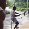 Young men in Point Hill, St Catherine, play a game of cricket in the streets to help pass the time as COVID-19 has turned many districts and villages into ghost towns.