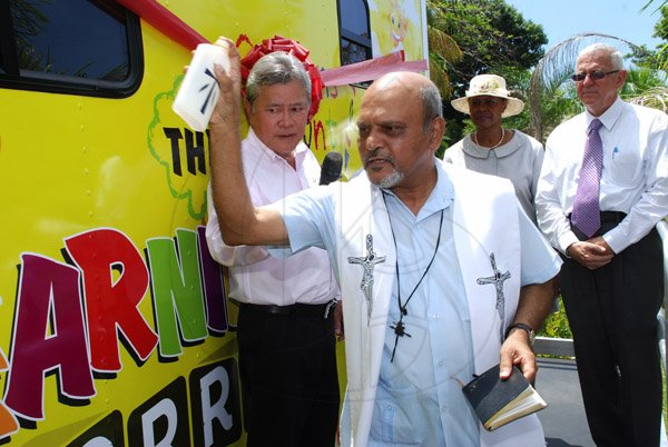 Colin Hamilton/Photographer                                                                                                                                                                                                                                                                                                                                                   Monsignor Gregory Ramkissoon (foreground) blesses the Learning Lorry, looking on in the background from left are Chairman of Continental Baking Company Butch Hendrickson, US Ambassador Pamela Bridgewater and Education Minister Ronald Thwaites.                                                                                                 ..............................................................................................................................................................................................Crayons Count Press Conference - April 18 - Hope Zoo