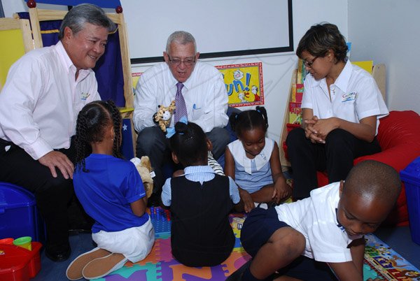 Colin Hamilton/Photographer                                                                                                                                                                                                                                                                                                                                                   (L>R) Chairman of Continental Baking Company Butch Hendrickson,  Education Minister Ronald Thwaites and Founder of Do Good Jamaica Deika Morrison interact with children inside the Mobile Classroom.                                                                                                ..............................................................................................................................................................................................Crayons Count Press Conference - April 18 - Hope Zoo