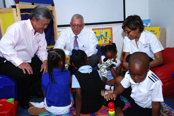 Colin Hamilton/Photographer                                                                                                                                                                                                                                                                                                                                                   (L>R) Chairman of Continental Baking Company Butch Hendrickson,  Education Minister Ronald Thwaites and Founder of Do Good Jamaica Deika Morrison interact with children inside the Mobile Classroom.                                                                                                ..............................................................................................................................................................................................Crayons Count Press Conference - April 18 - Hope Zoo