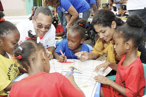 Gladstone Taylor / Photographer

Christopher Barnes, managing director of The Gleaner Company and Lisa Hanna, minister of youth and culture interact with children from basic schools downtown Kingston, during an after school event at The Gleaner's parking lot along east street. The schools were chosen by the National Child Month Committee.