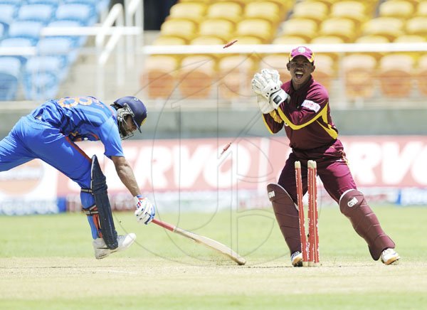 Ricardo Makyn/Staff Photographer
Indian Batsman Kohli is run out by Wicket Keeper Baugh for  94 at Sabina Park on  Thursday16.6.2011