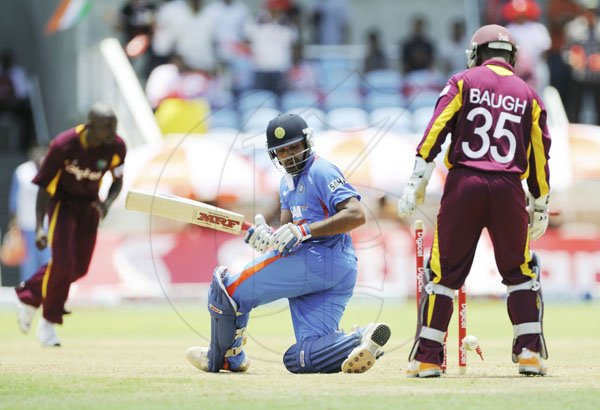 Ricardo Makyn/Staff Photographer
India's Sharma is Bowled by West Indies Martin for 57 while Wicket Keeper Baugh Looks on at Sabina Park on  Thursday16.6.2011