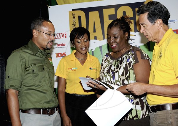 Winston Sill / Freelance Photographer
Sports management specialist Carole Beckford (second right) pointing to aspects of her presentation at last night's launch of The Gleaner's Daegu to London, Olympic coverage at the Knutsford Court Hotel, Ruthven Road,  St Andrew. Looking on are The Gleaner's managing director Christopher Barnes (left), senior corporate communications officer, Supreme Ventures Limited, Carlene Edwards (second left) and Carl Chang of Puma Jamaica.
