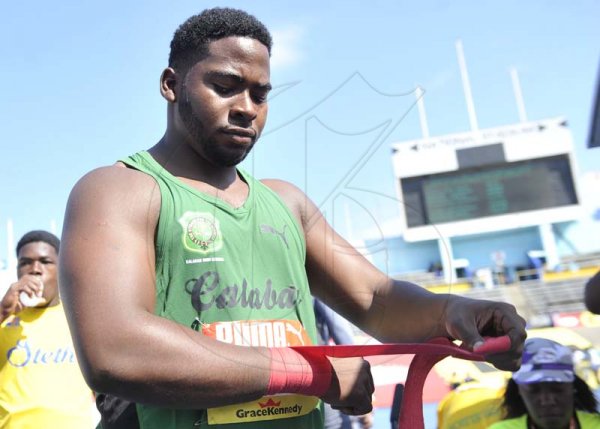 Shorn Hector/Photographer Coby Graham of Calabar raps him wrist before competing in the boys class one shot put on day four of the ISSA/GraceKennedy Boys and Girls’ Athletics Championships held at the The National Stadium in Kingston on Friday March 29, 2019