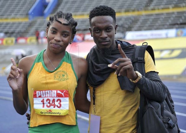 Shorn Hector/Photographer Chantal Gayle of Vere Technical shares a photo with coach Elon Murdock after winning the final of the girls class three High Jump on day three of the ISSA/GraceKennedy Boys and Girls’ Athletics Championships held at the The National Stadium in Kingston on Thursday March 28, 2019