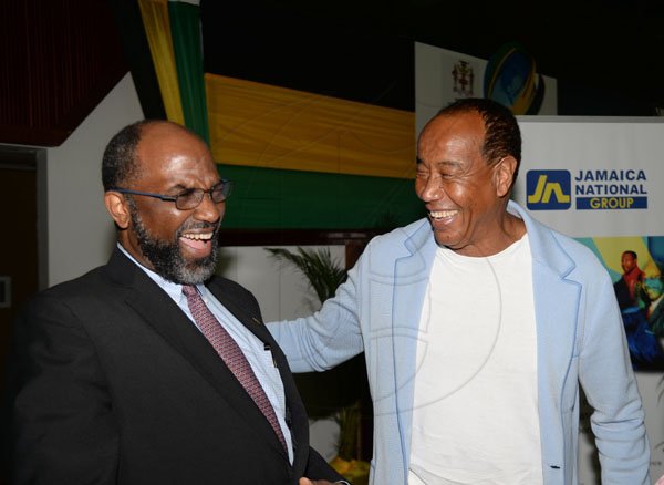 Jermaine Barnaby/ Freelance PhotographerHon. Michael Lee-Chin (right) chairman of the Economic Growth Council and Earl Jarret, General Manager of the Jamaica National Group, enjoying each others company at the Jamaica Diaspora 55 held at the Jamaica Conference Centre in Kingston on Tuesday July 25, 2017.