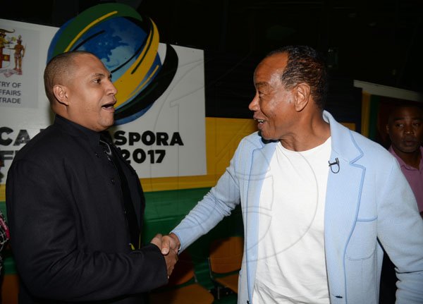 Jermaine Barnaby/ Freelance PhotographerHon. Michael Lee-Chin (right) chairman of the Economic Growth Council is greeted by Dr. David Panton,  EGC, Diaspora Task Force/ Panton Equity Partners just before the start of the Jamaica Diaspora 55 at the Jamaica Conference Centre in Kingston on Tuesday July 25, 2017.