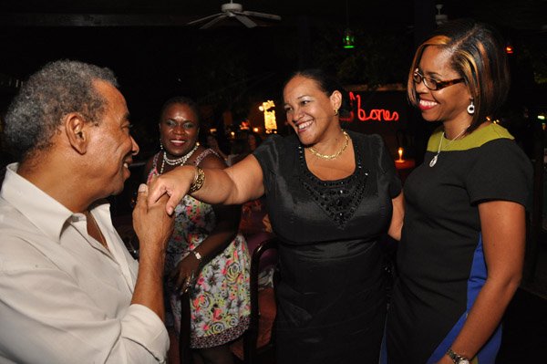 Jermaine Barnaby/Photographer
Hope Mc Millan- Cowan (center) is welcomed with guest Simone Mahabeer (right) to Redbones by proprietor Evan Williams (left) during The Gleaner's Pre-Restaurant Week Dinner Promotions 2013 with Karin Cooper and guests at  Red Bones on Tuesday, November 5, 2013. Looking on is Carol Archer.