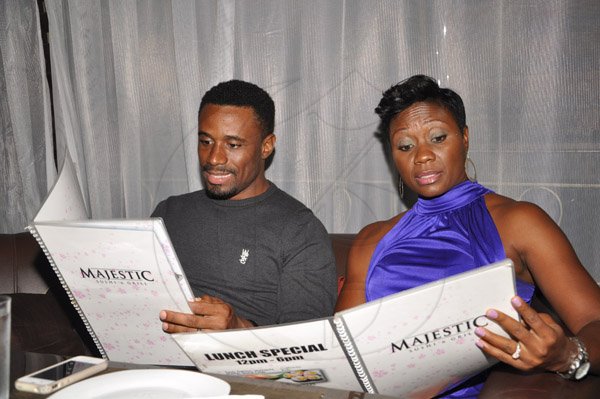 Jermaine Barnaby/Photographer
Restaurant Week Ambassador Juilet Flynn and husband Levaughn browse through the  menu at Majestic Sushi and Grill, Valla Ronai, Old Stony Hill on Wednesday, October 30, 2013.