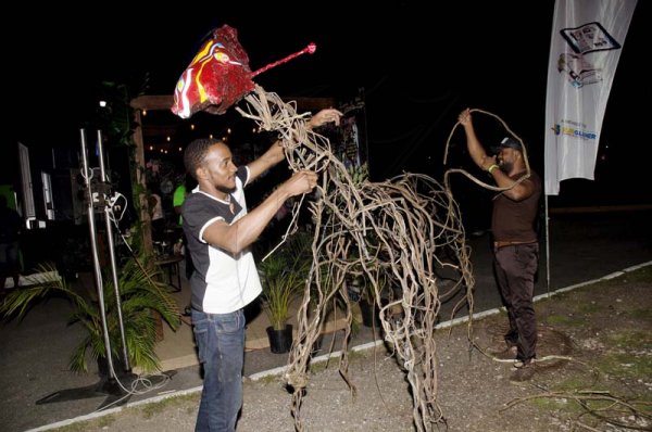 Shorn Hector/Photographer   Artist Toby Grant (in back) gets help from patron Kadeem Nooks to complete his sculpture of a six legged horse at the Earth Hour concert held at Ranny William Entertainment Centre on March 25, 2018