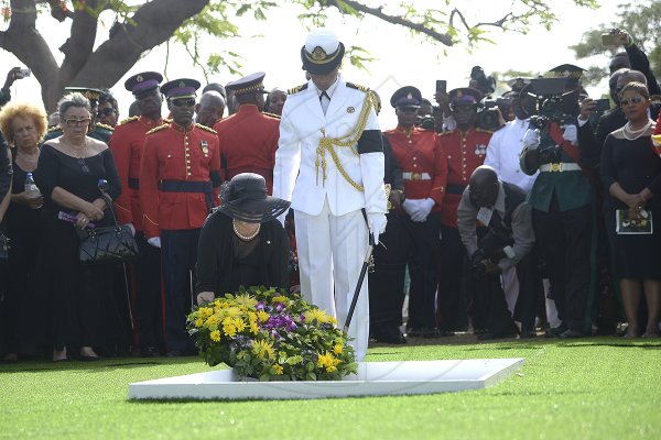 Shorn Hector/Photographer Carla Seaga lays a wreath on the entombed area of the late Edward Seaga at the National Heroes Cricleon Sunday June 23, 2019.