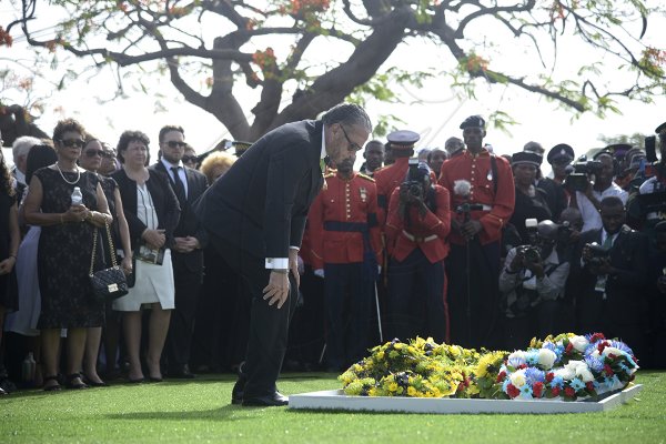 Shorn Hector/Photographer Tom Tavares-Finson, Attorney-at-law, looks on after laying a wreath on the entombed area of the late Edward Seaga at the National Heroes Cricleon Sunday June 23, 2019.