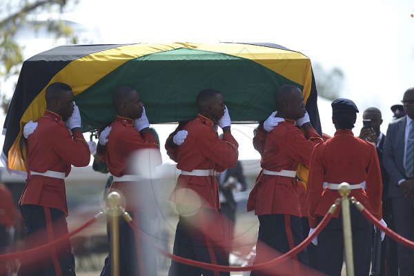 Shorn Hector/Photographer Members of the First Battalion Regiment (1JR) bearer party carry the flag drapped coffin bearing the remains of the late Edward Seag  at the National Heroes Park during the burial ceremony of the late Edward Seaga, former Prime Minister of Jamaica, on Sunday June 23, 2019