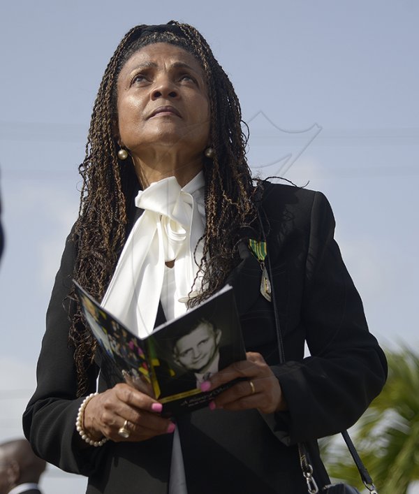 Shorn Hector/Photographer Carlene Davis looks to the heavens during the burial ceremony of the late Edward Seaga, former Prime Minister of Jamaica, on Sunday June 23, 2019