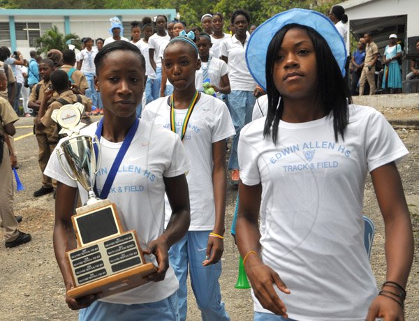 Jermaine Barnaby/Photographer
Members of the Edwin Allen's team which include captain Danique Bryan (right) as they make their way with the Championship trophy during a celebration at the school on Monday March 30, 2015.