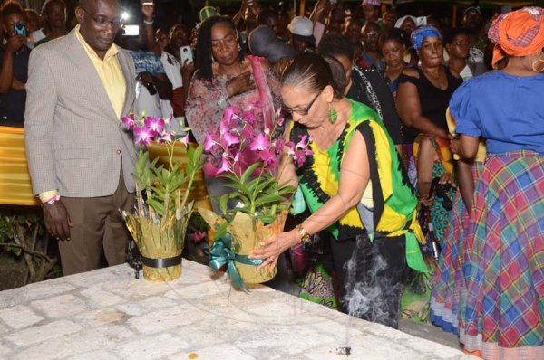 Shorn Hector/Photographer  Minister of Labour and Social Security, Shahine Robinson lays a floweral arrange on the tomb of Africans who are buried on site at the Seville Emancipation Jubilee 2018