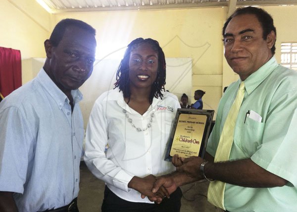 Contributed 
Fabian Ford (right), the principal of Bethel Primary & Junior High School, in Hanover, accept a Gleaner 'Youth Link Plaque' from Denique Mattis (centre), the head of circulation for the Gleaner Company in western Jamaica. Kenneth Rowe, the Chairman of the school's board of governors, shares in the occasion.