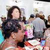 Rudolph Brown/ PhotographerJune Gottgens (right) showcase samples of her product, umium coconut chocolate spread at the JEA JMA Expo Jamaica at the National Indoor Sports Centre and the National Arena on Sunday April 22, 2018