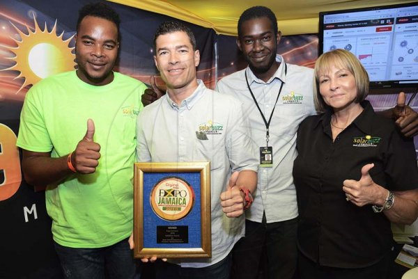 Rudolph Brown/ Photographer<\n>Jason Robinson, (second left) CEO of Solarbuzz Jamaica, Janette Robinson, Director, Curtis Rolston, (left) Senior Solar Technician and Anthony Henry pose with the winning Trophy for Expo Jamaica 2018 Exhibitor award for Environmentally Friedly Exhibit Product at the JEA JMA Expo Jamaica at the National Indoor Sports Centre and the National Arena on Sunday April 22, 2018<\n><\n><\n>